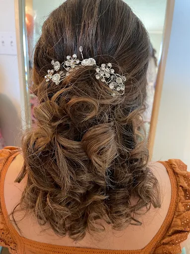 Curled updo with floral hair accessories
